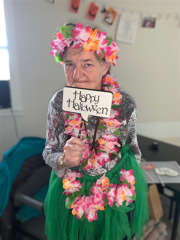 a woman wearing a flower necklace and flower headdress