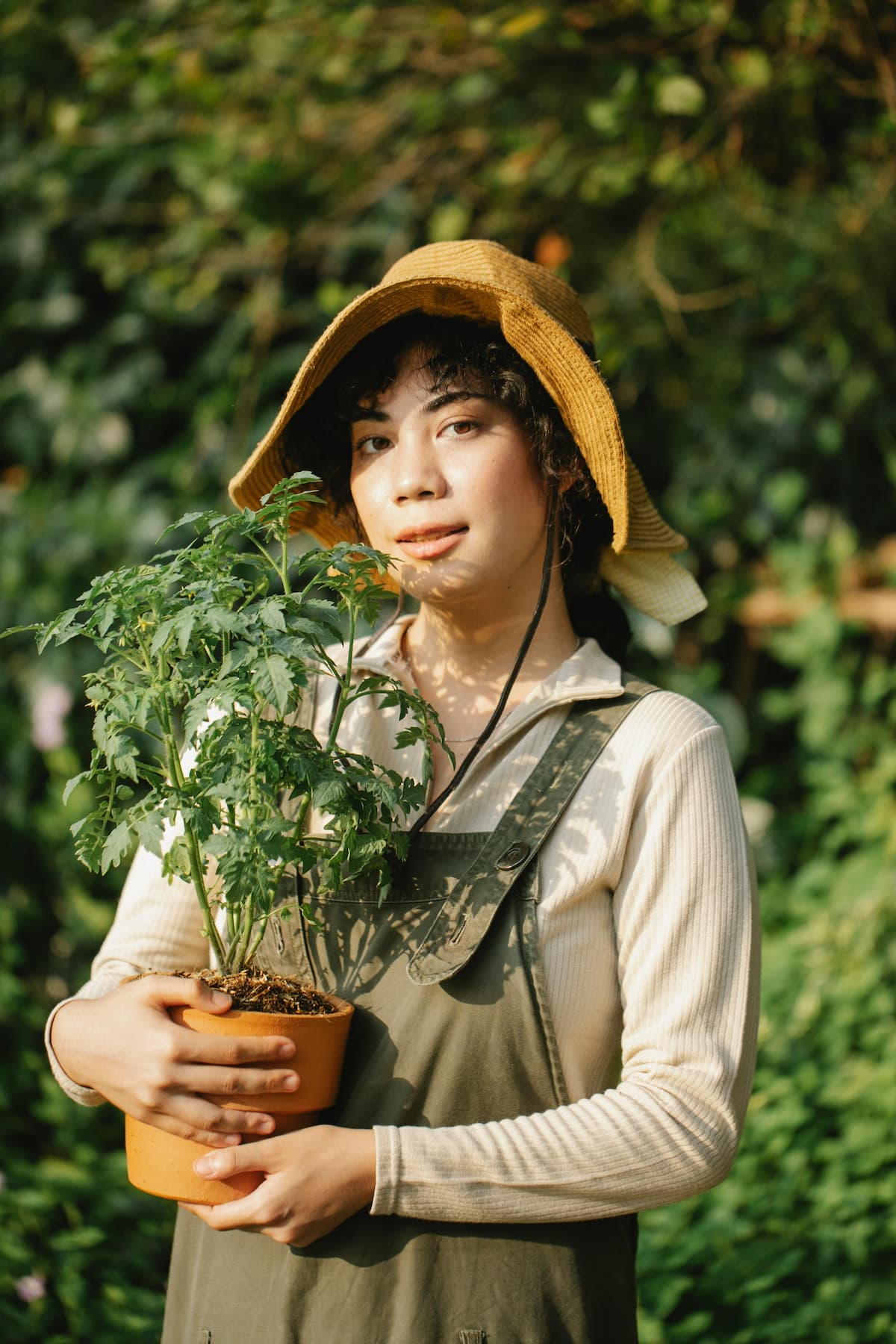 woman holding a potted plant